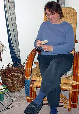 Nancy in her coiling corner, working on a hemp basket