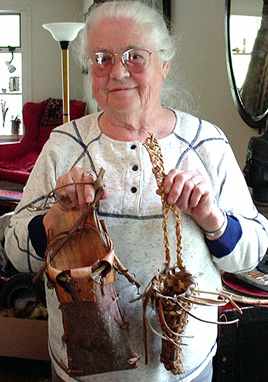 Persis shows off two small  basket pouches, which hang on the wall