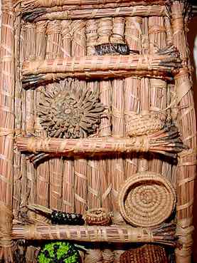 Tiny pine needle shelf, filled with miniature coiled baskets, by Nancy Latham