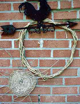 flat wicker basket of vines displayed on a brick wall in Nancy's yard
