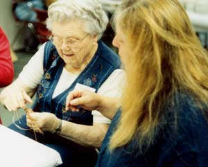 Gladys helping Lynn start her basket